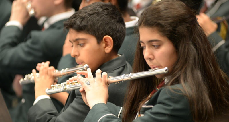 two students playing the flute at a bvg concert